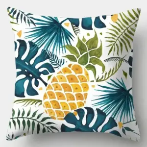 Kissenbezug mit Ananas und blauen Palmblättern auf grauem Hintergrund